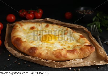 Fresh Delicious Adjarian Khachapuri Served On Black Table