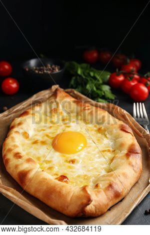 Fresh Delicious Adjarian Khachapuri Served On Black Table, Closeup