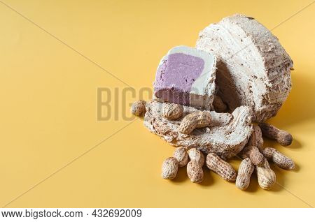 Peanut Halva With Peanuts On A Bright Yellow Background Of The Mine Space. Halva Made Of Oriental Sw