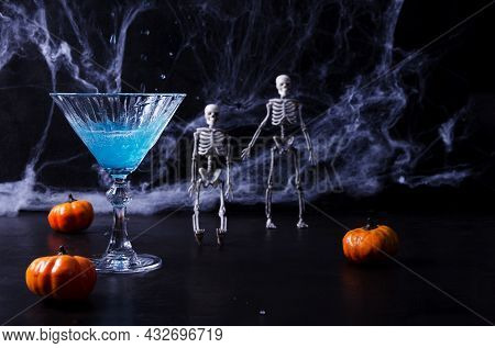 Blue Drink For Halloween, Dia De Murtos On A Black Background, In The Background Of Cobwebs, Skeleto