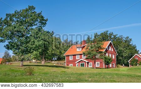 Vastervik, Sweden - 08.23.2021: Typical Red Wooden Countryside House In Nature Of Southern Sweden On