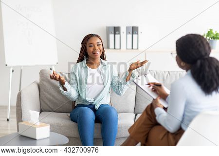 Effective Therapy. Happy Young Black Woman Having Session With Psychologist, Grateful For Profession