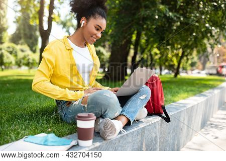 Successful African Student Girl With Laptop Computer Learning Online Outdoor