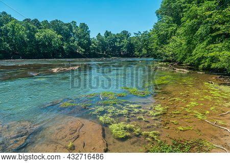 Looking Downstream Wide Angle View Of The Chattahoochee River With People Fishing And Canadian Geese