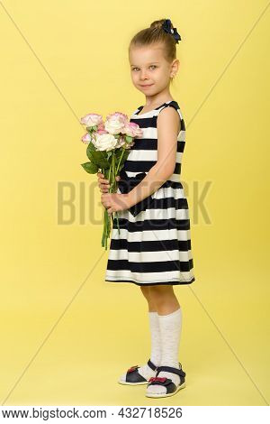Cute Little Girl In Nice Dress With Bouquet Of Flowers. Half Turned Full Length Portrait Of Pretty L