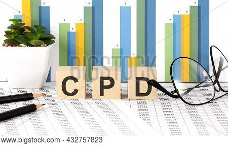Cdp Word Written On Wood Block With Chart, Glasses And Pencils