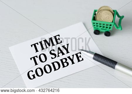 Card With The Text Time To Say Goodbye On The Table Next To A Pen And Coins