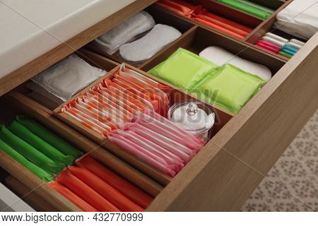 Storage Of Different Feminine Hygiene Products In Wooden Drawer, Closeup