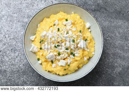 Tasty Banosh Served With Brynza And Cut Green Onions On Grey Table, Top View. Traditional Ukrainian 