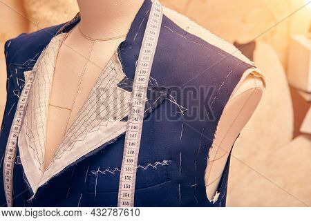 Semi-ready Jacket On Mannequin With Measuring Tape Across Neck. Suit Tailoring In Process Of Custom-