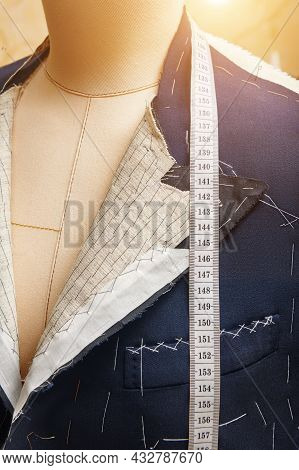 Semi-ready Jacket On Mannequin With Measuring Tape Across Neck. Suit Tailoring In Process Of Custom-