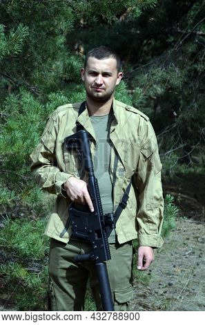 Man with KRISS Vector 9*21 caliber submachine gun in the forest. Unformal shooting range near Kiev. September 6,2021. Kiev Region, Ukraine