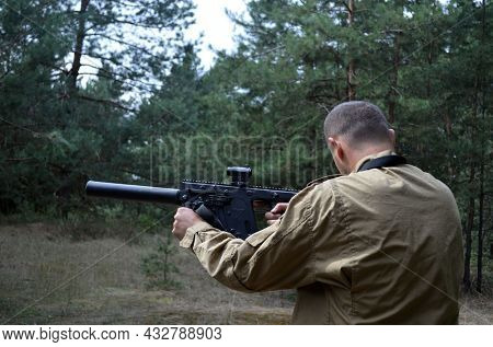 Man with KRISS Vector 9*21 caliber submachine gun in the forest. Unformal shooting range near Kiev. September 6,2021. Kiev Region, Ukraine