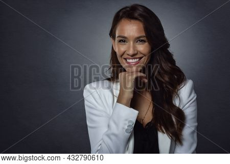 Studio Portrait Shot Of Attractive Middle Aged Woman With Toothy Smile Wearing Blazer While Standing