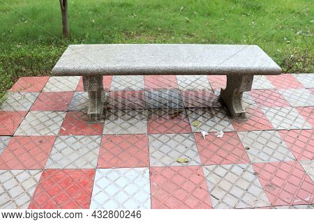 Park Bench Front Red Stone Footpath And Green Grass Backside