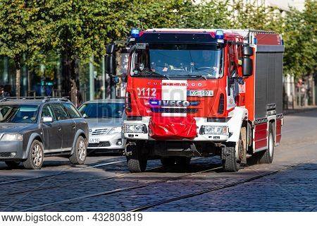 Riga, Latvia - October 7, 2020:a Fire Truck With Warning Lights On Goes To A Call On A Paved Street 