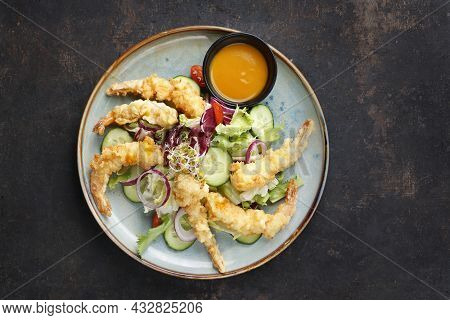 Top View Of A Salad With Prawns In Panko, Served With Oriental Sauce Based On Mango And Garlic. Orie