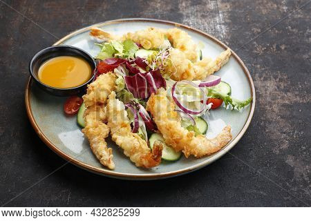 Close Up Of A Salad With Prawns In Panko, Served With Oriental Sauce Based On Mango And Garlic. Orie