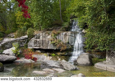 Stone Mountain Waterfall And Lake. A Picturesque Cascade Waterfall Among Large Stones In The Landsca