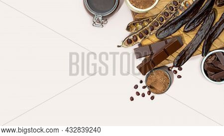 Organic Carob Pods, Powder And Carob Molasses On A Beige Background, Locust Bean Healthy Food, Cerat