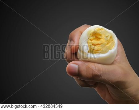Closeup Image Of Child Holding Sliced Boiled Chicken Egg. Black Isolated Background. Selective Focus