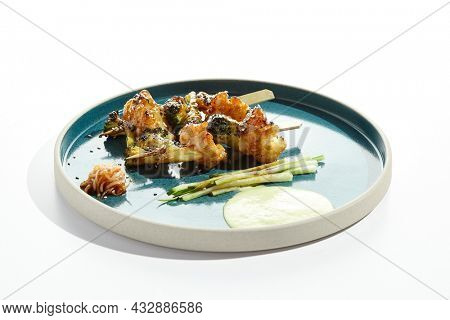 Vegetarian food - vegetables in skewers in teriyaki sauce. Grilled vegetables on bamboo stick in Japanese style. Vegan menu for asian restaurant. Eat less meat. Plant - based eating