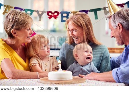 Grandparents With Mother And Grandchildren Celebrating With First Birthday Party At Home