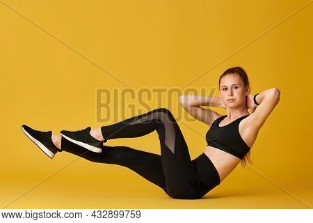 Girl In Black Sportswear Doing V-ups Abs Workout