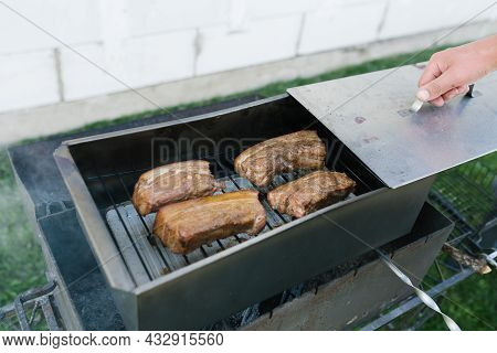 A Man's Hand Opens A Smokebox With Lard In Nature