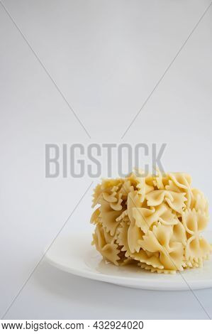 Farfalle Cooked Farfallini Pasta In A Shape Of Square On A White Plate.