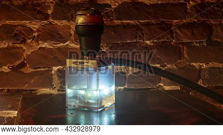 Hookah Square Flask On The Wooden Table. Original Square Designer Hookah.