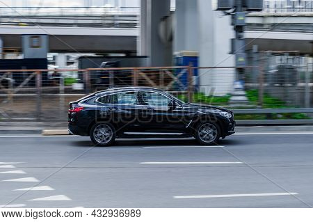 Bmw X4 Crossover Driving Along The Street In City With Blurred Background. Moscow, Russia - August 2