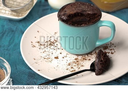 Mugcake Is Microwaved. Homemade Cupcake In A Mug Is On A Plate.
