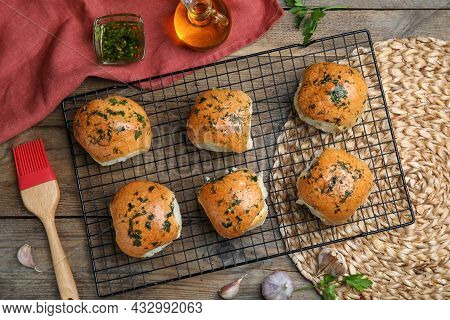 Traditional Ukrainian Bread (pampushky) With Garlic On Wooden Table, Flat Lay