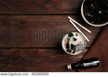 Glass Of Milk With Grass Jelly On Wooden Table, Flat Lay. Space For Text