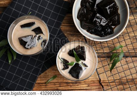 Glasses Of Milk With Grass Jelly On Wooden Table, Flat Lay