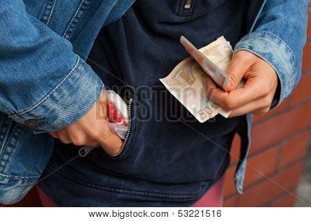 Drug Dealer Hiding Pills In His Pocket