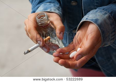 Girl Holding Vodka,pills And Cigarettes