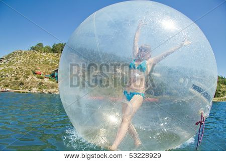 Joyful Girl In A Balloon Floating On Water.