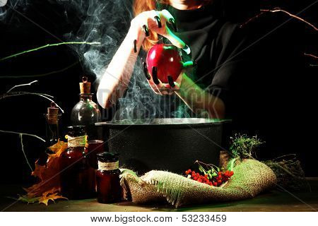  Witch in scary Halloween laboratory on dark color background