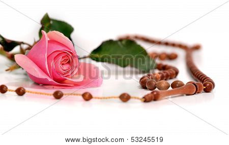 Muslim Rosary And Pink Rose On A White Background