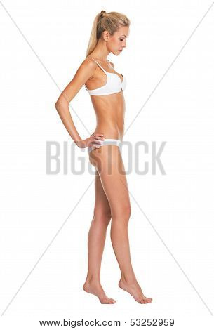 Full Length Portrait Of Young Woman In Lingerie Going Sideways