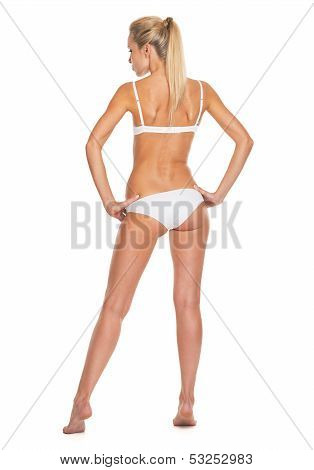 Full Length Portrait Of Young Woman In Lingerie . Rear View