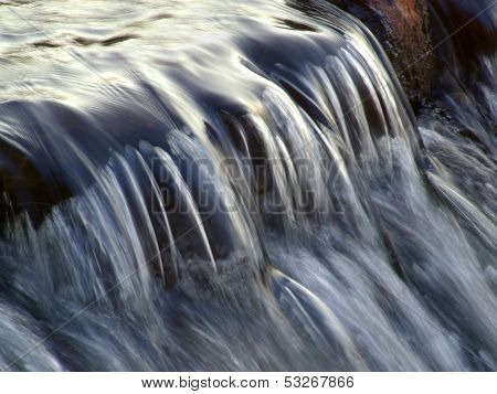 Flowing water taken with a slow shutter speed in a river stream
