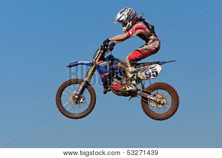 BLOEMFONTEIN, SOUTH AFRICA - JULY 19: Unidentified motocross rider jumps through the air during a national motocross racing event, on Jul 19, 2009 in Bloemfontein, South Africa.
