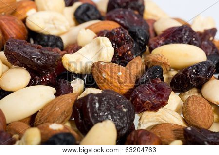 mixed nuts and dried fruits isolated on white background