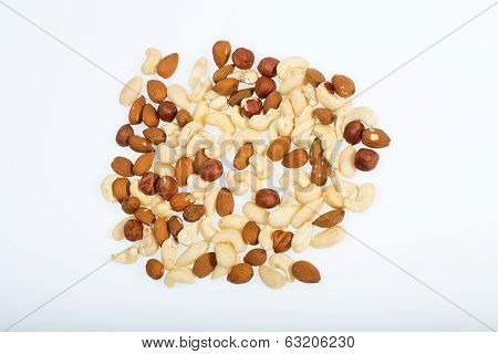 mixed nuts - hazelnuts walnuts cashews pine nuts isolated on white background