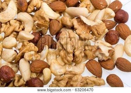 background of mixed nuts - hazelnuts walnuts cashews pine nuts