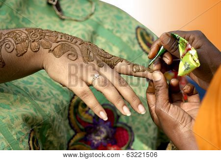 Applying henna- temporary tattooing
