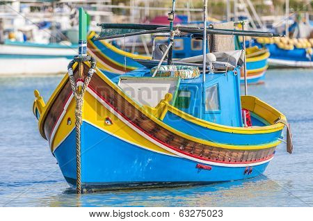 Traditional Luzzu Boat At Marsaxlokk Harbor In Malta.